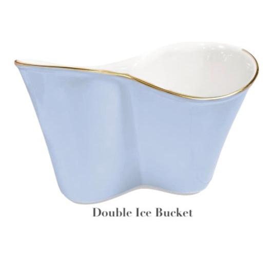 A light blue double ice bucket from Beatriz Ball's Encanto Periwinkle Serveware Collection, crafted from aluminum alloy with a wavy shape, white enameled interior, and gold rim, labeled "Double Ice Bucket" below.