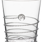 A clear glass tumbler from the Juliska Amalia Drinkware Collection features a textured spiral wrapping the exterior and a raised circular accent, showcasing intricate details crafted by master glass artists.