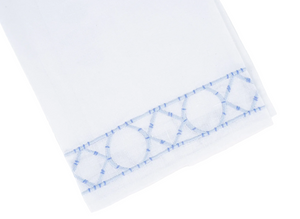Transform your home décor with the Haute Home Bamboozle Bath Collection—crisp white Italian linen featuring a decorative blue embroidered border with an eye-catching geometric circular and diamond pattern along one edge.