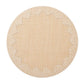 The Dream Weaver Placemat by Kim Seybert features a round, light tan woven design with white-stitched, starburst-style jagged edges—ideal for summer entertaining.