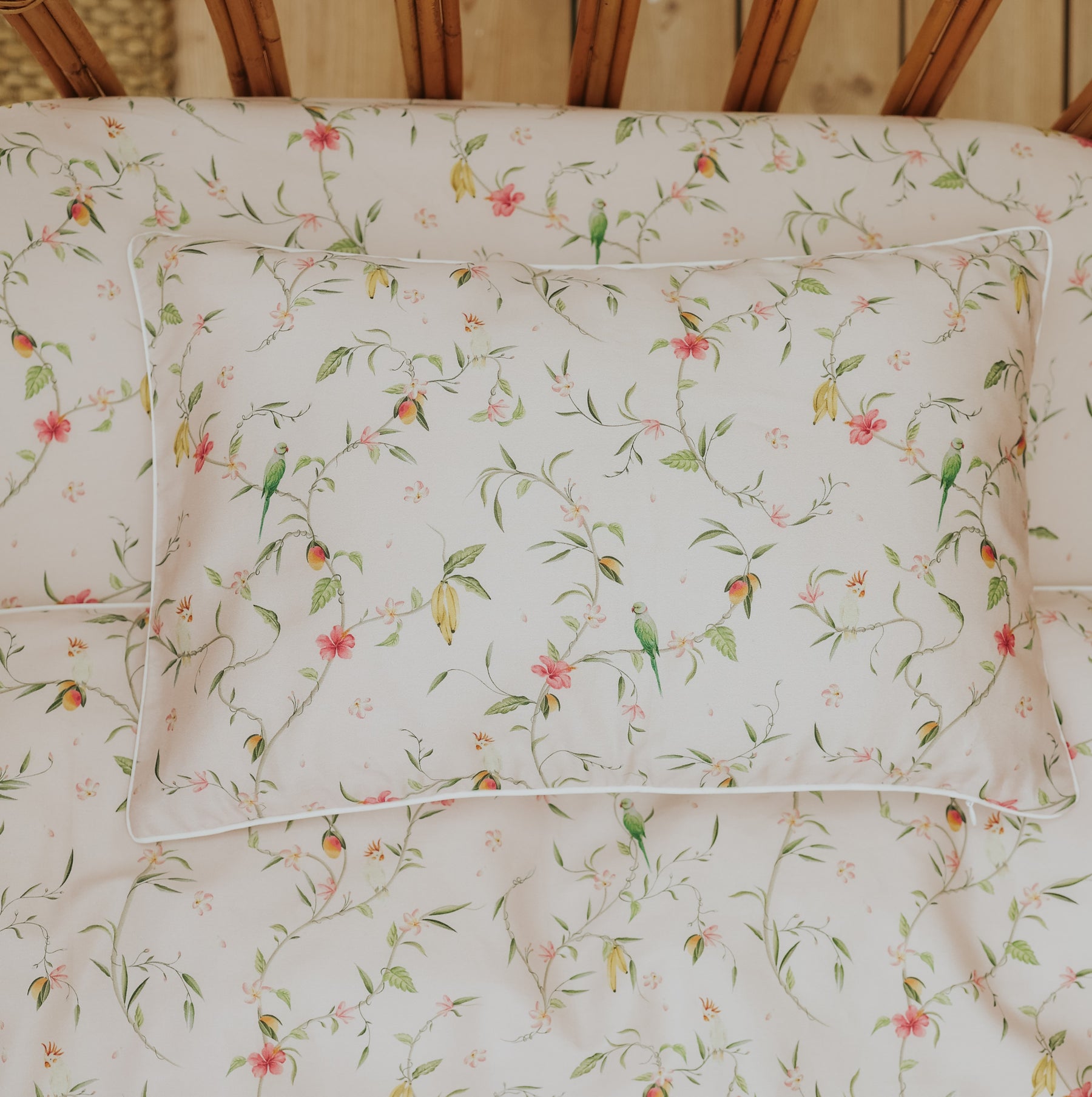The Gooselings Dreaming of Paradise Toddler Pillow features a delicate floral and green bird print on a white background—perfect for little ones to enjoy sweet dreams.