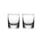 Two empty clear glass tumblers from Simon Pearce’s Ascutney Drinkware Collection sit side by side on a white background, highlighting elegant handmade barware ideal for Irish whiskey.