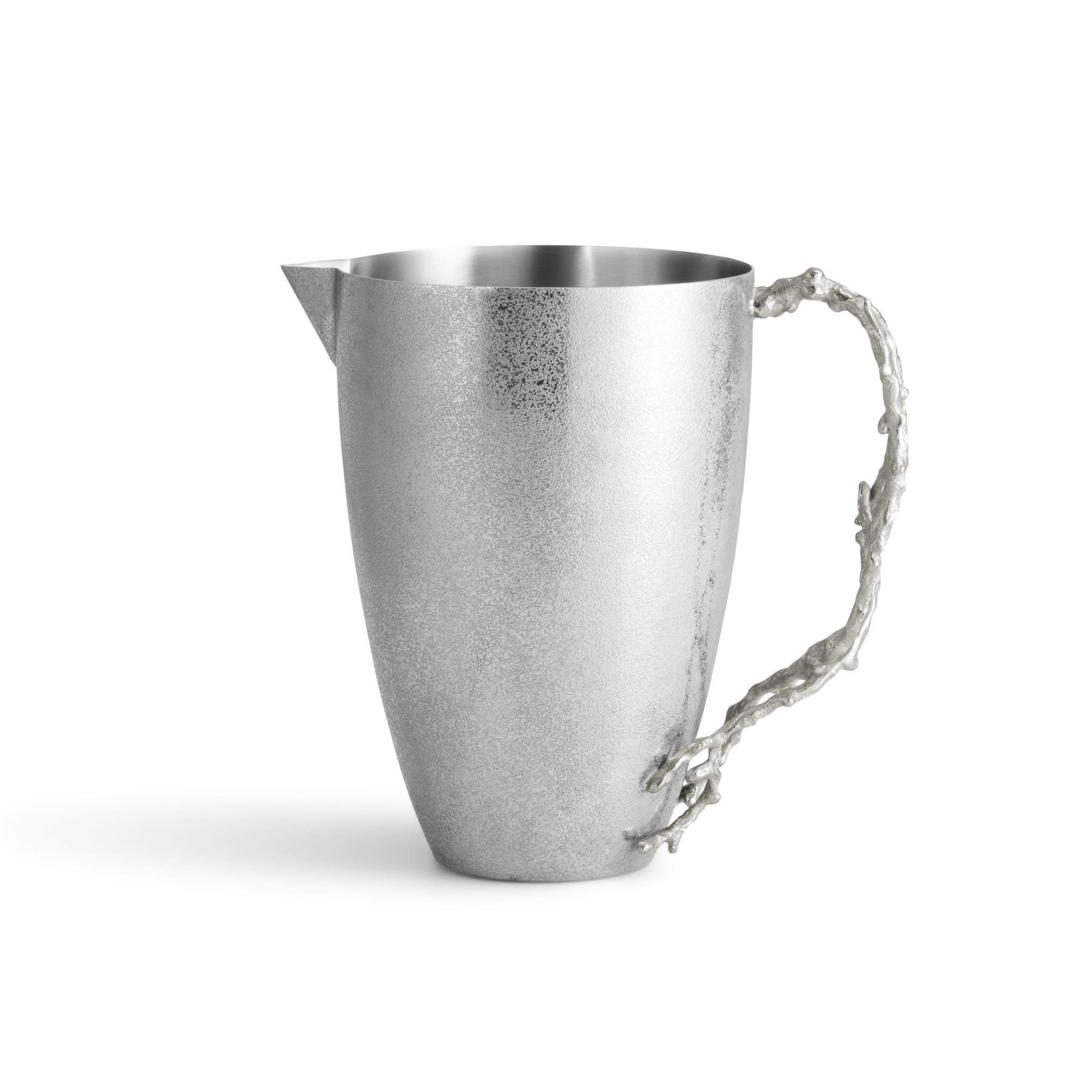 A silver metal pitcher from the Michael Aram Ocean Reef Serveware and Barware Collection features a textured surface and branch-like handle, evoking coral reefs, displayed against a plain white background.