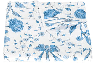 A folded white sheet with a blue floral pattern, crafted from Egyptian cotton percale, Matouk Schumacher Khilana Bedding Collection, Azure by Matouk.