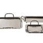 The Manetta Polished Nickel Tray Collection by Zodax features three trays in varying sizes, each with decorative handles, creating an elegant set perfect for serving, all displayed against a white background.