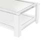 The Surrey Acrylic Rectangular Cocktail Table by Interlude Home features thick legs and a lower shelf, ideal for contemporary living rooms, shown photographed on a white background.