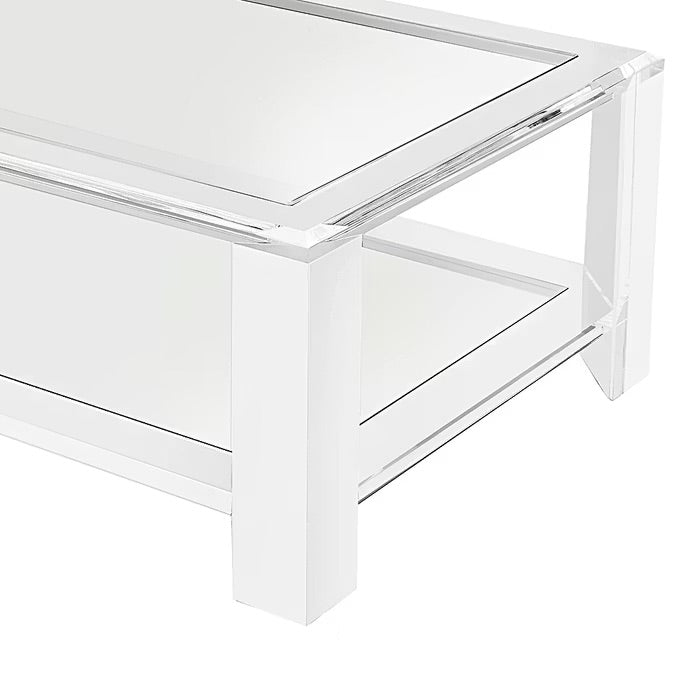 The Surrey Acrylic Rectangular Cocktail Table by Interlude Home features thick legs and a lower shelf, ideal for contemporary living rooms, shown photographed on a white background.