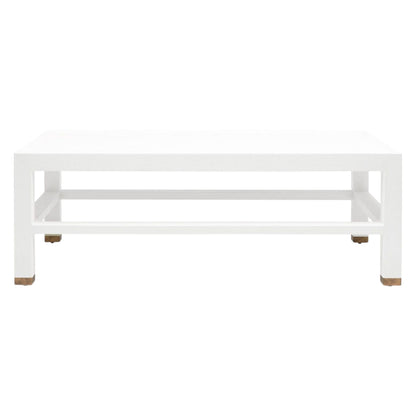 The Made Goods Jarin Coffee Table in Designer White Belgian Linen features a textured rectangular design, lower shelf, and small brown feet, displayed against a plain white background.
