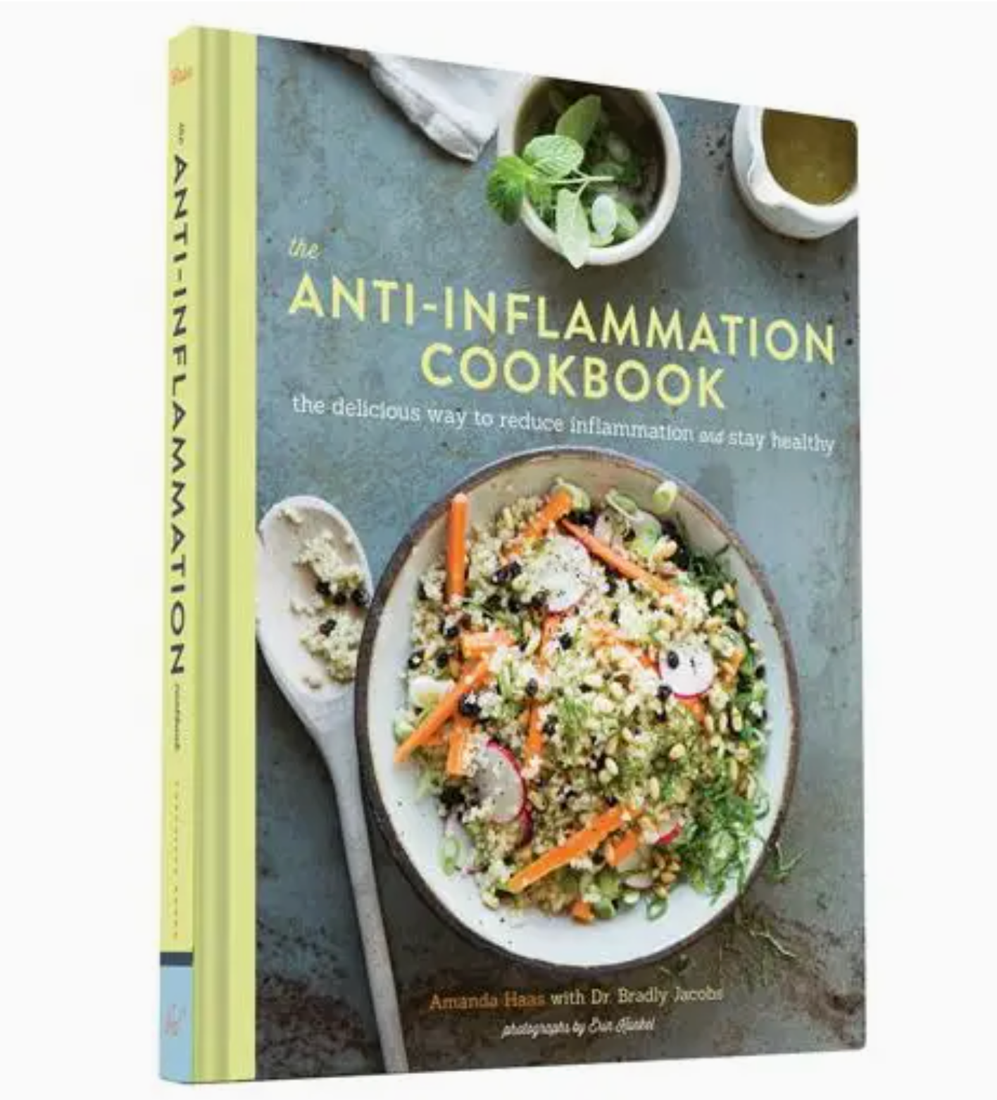 Rewritten sentence: “The Anti-Inflammation Cookbook by Chronicle Books, showcasing a vibrant quinoa salad in a white bowl on its cover alongside serving utensils and condiments, features delicious anti-inflammatory recipes made with wholesome ingredients.”.