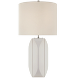 The Carmilla Medium Table Lamp in Matte White by Visual Comfort features a geometric ceramic base and a cylindrical linen shade, displayed against a plain background.