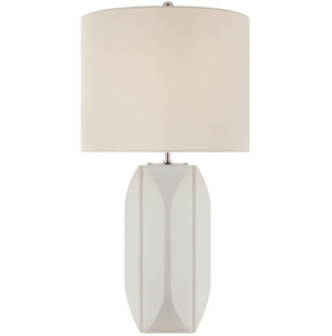 The Carmilla Medium Table Lamp in Matte White by Visual Comfort features a geometric ceramic base and a cylindrical linen shade, displayed against a plain background.