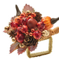 The Kim Seybert Cornucopia Napkin Ring features artificial red berries, pomegranates, pinecones, gold ornaments, and fall leaves—a festive accent for Thanksgiving or autumn table decor.