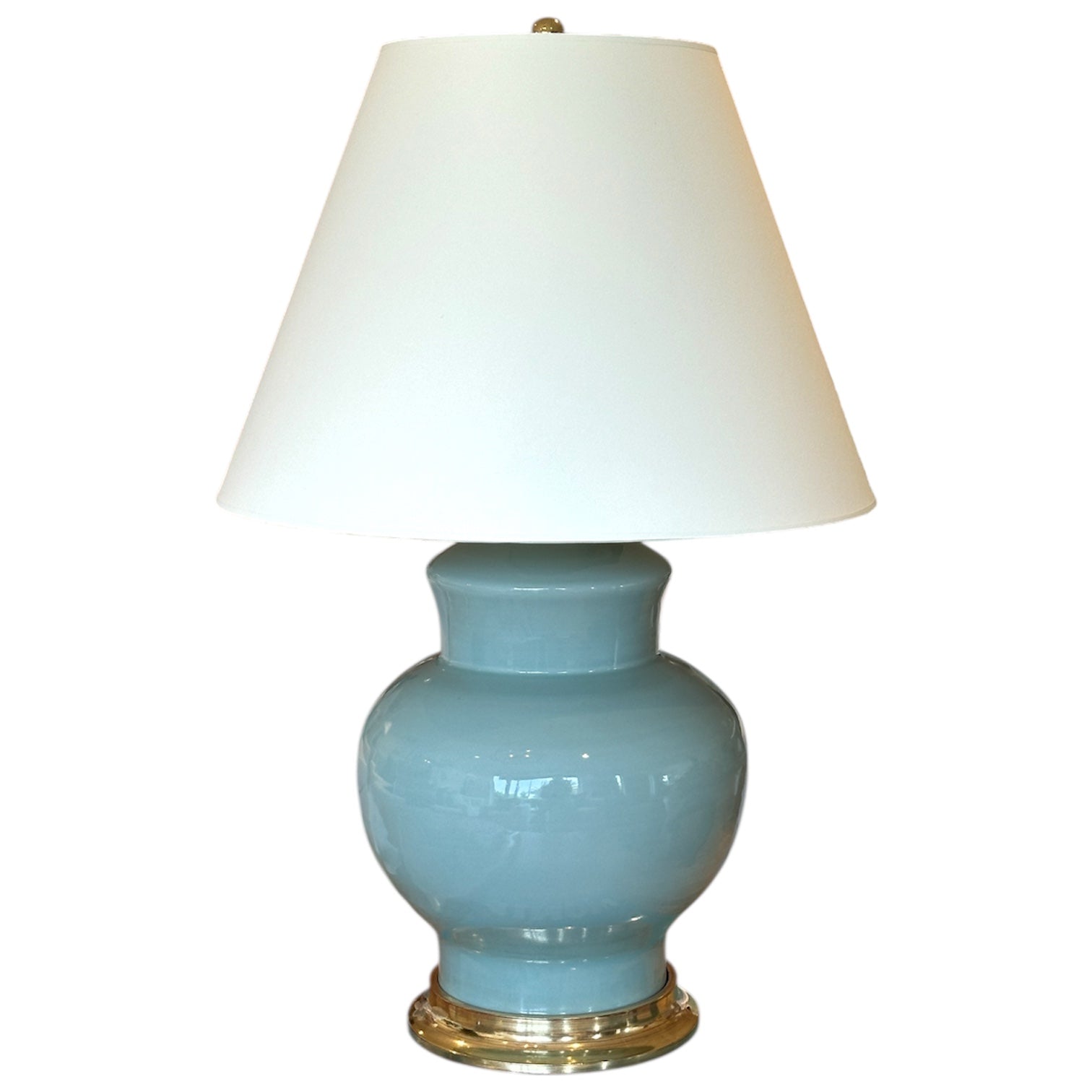 The Kim Lamp in Duck Egg by Christopher Spitzmiller features a glossy blue ceramic base, gold accent, and white tapered shade—an ideal touch for cozy corners.