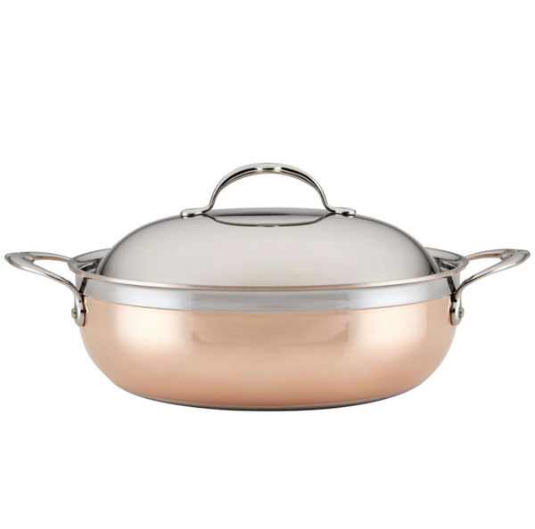 The Hestan CopperBond 5qt Dutch Oven, featuring a copper and stainless steel design, includes a lid and side handles. It's compatible with induction cooktops for versatile cooking performance.