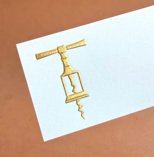 The Printery Gold Corkscrew Place Card Set features white tented cards with a gold corkscrew illustration on a brown background.