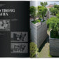 Homes For Our Time by Taschen: An open book reveals architectural plans and a contemporary house by Vo Trong Nghia, featuring rooftop gardens and lush greenery—a stunning example of modern home design.