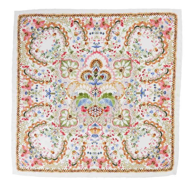 Add a touch of fantasy garden charm to your table with the Sofia Napkin Set by Juliska, featuring a square cotton napkin adorned with an intricate, symmetrical floral and scroll pattern in green, pink, brown, blue, and yellow on white.