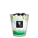 A decorative Baobab Collection Eden Forest candle in a multicolored glass holder with a black label and ribbon.