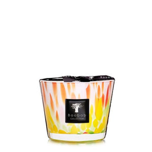 A colorful Baobab Collection Eden Garden candle with a flame-like design on the glass container, set against a plain white background.