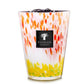 A decorative Baobab Collection Eden Garden Candle baobab candle in a multicolored glass holder with red, yellow, and white patterns.