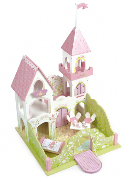 Fairybelle Palace, a wooden toy castle with a pink and green roof.