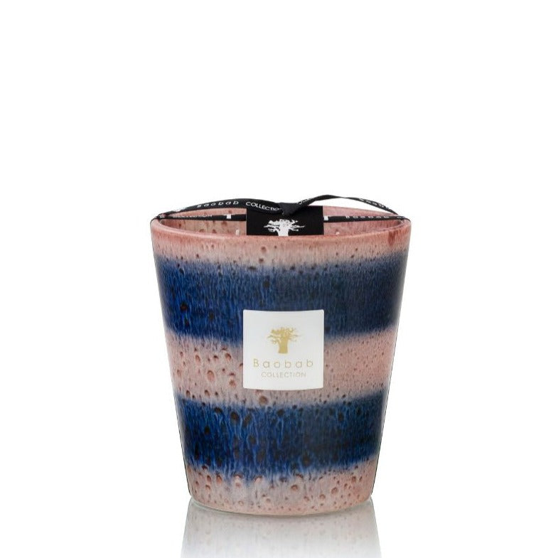 A Baobab Collection Elementos Téthys Candle in a multicolored glass jar, predominantly pink and blue, against a white background.
