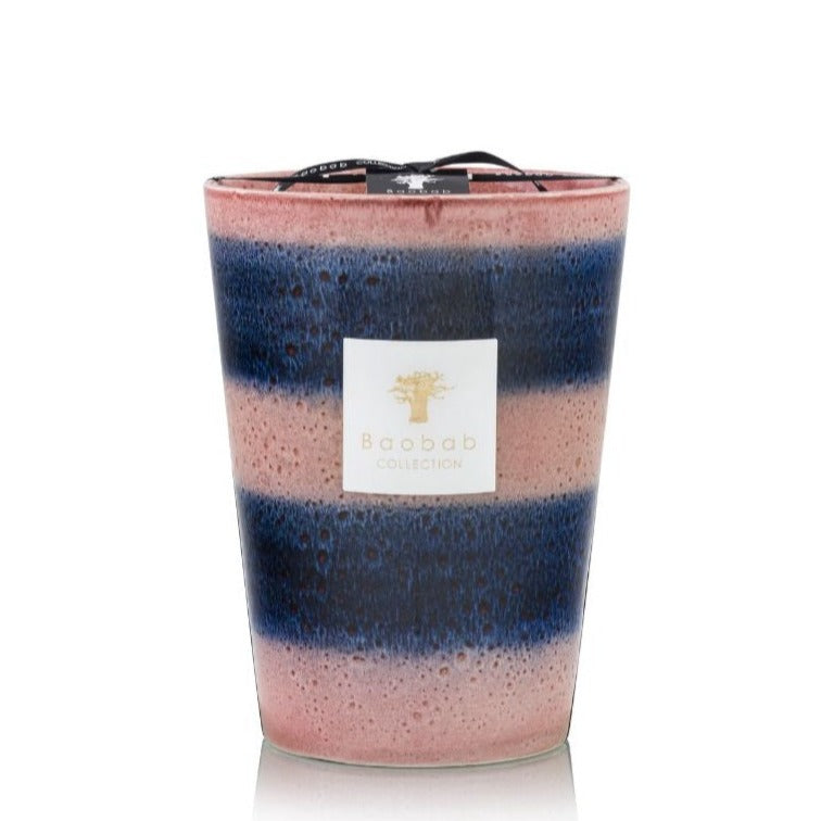 A Baobab Collection Elementos Téthys Candle in a multicolored glass container with shades of pink and blue, isolated on a white background.