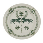 The Casa Dark Jungle Dinnerware Collection by Johanna Ortiz features a white plate with green designs of two leopards amid leaves and florals—ideal for mix-and-match tablescapes or as a standout, hand-painted ceramic piece.
