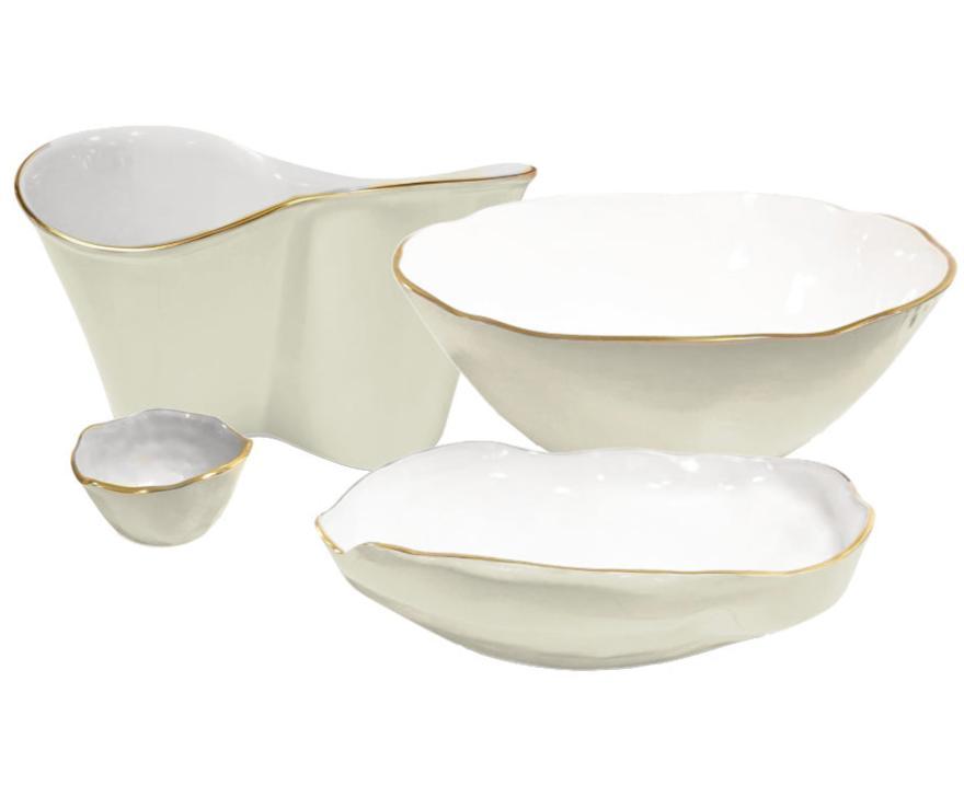 Four white ceramic dishes of varying sizes with irregular edges and gold trim are arranged together, showcasing the elegance of the Encanto Cream Serveware Collection by Beatriz Ball.