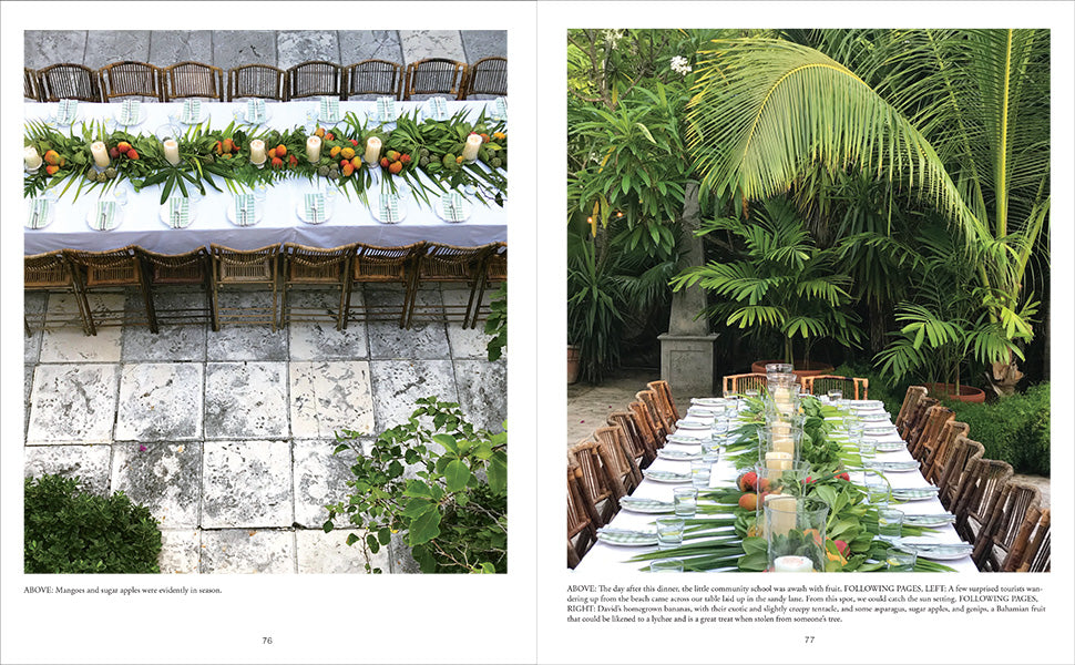 A long outdoor dining table draped in white, paired with wooden chairs and a centerpiece of tropical leaves and fruit—set on a stone patio amid lush greenery—captures the party inspiration found in “An Entertaining Story” by Common Ground.