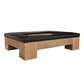 The Mikos Cocktail Ottoman by Hickory Chair features a large square wooden frame with substantial legs and a recessed center, accented by a sleek black cushioned border—an eye-catching, modern piece that seamlessly fuses contemporary style with refined sophistication.