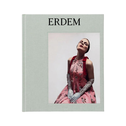 A hardcover book titled “Erdem” from Rizzoli features a cover image of a woman in a pink floral dress with lace gloves, posing with her head tilted back—an elegant tribute to the iconic style of British designer Erdem Moralioglu.