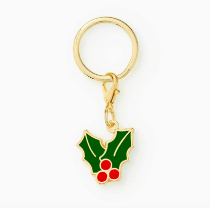 The Foggy Dog Holly Collar Charm is a gold keyring featuring green holly leaves and three red berries, outlined in gold—a cheerful festive accessory or perfect holiday collar charm.