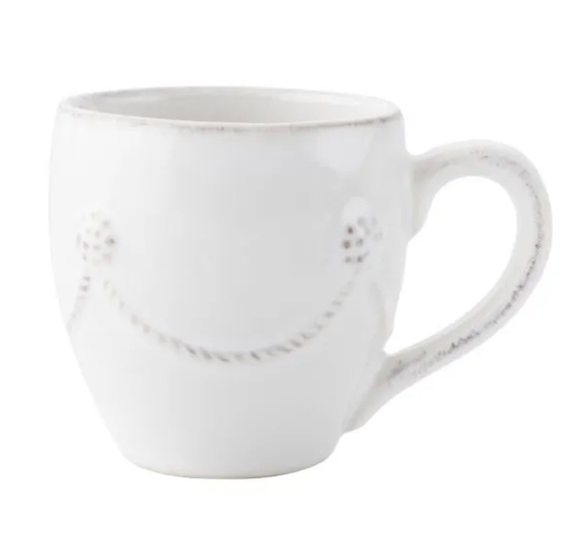A white ceramic mug from the Juliska Berry & Thread Classic Whitewash Dinnerware Collection, featuring a curved handle and a subtle embossed garland design.