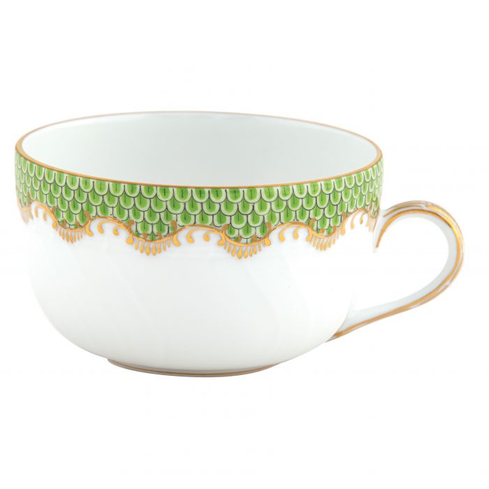 This white ceramic cup, part of the elegant Herend Fish Scale Evergreen Collection by Herend, features a hand-painted green and gold scalloped design along the rim and a gold-trimmed handle. This exquisite piece makes an ideal wedding or anniversary gift.