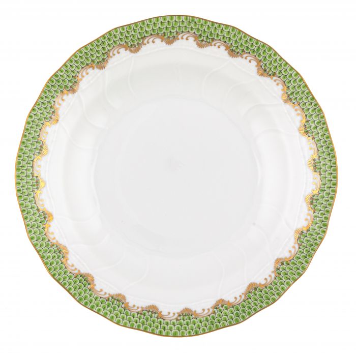 White porcelain plate with scalloped edges, a green and gold patterned rim, and a smooth center. This hand-painted Herend Fish Scale Evergreen Collection piece makes an excellent wedding or anniversary gift.