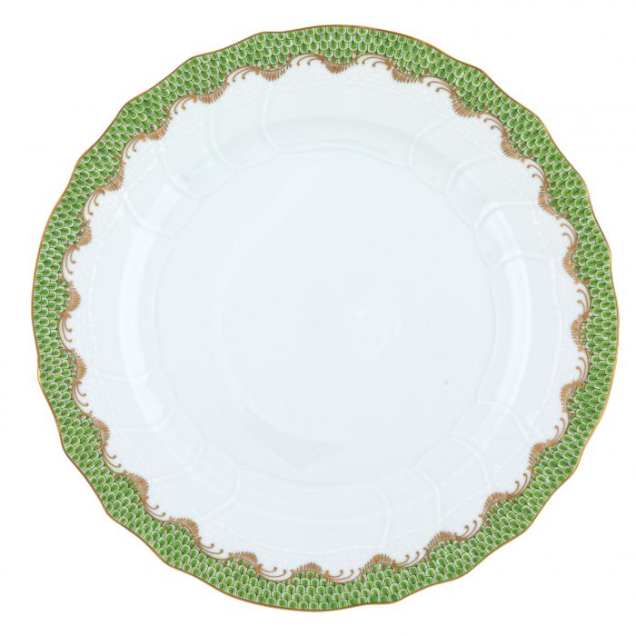 A white ceramic plate with textured edges from the Herend Fish Scale Evergreen Collection by Herend features an iconic green and gold pattern around the rim, reminiscent of their classic design.