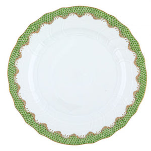 A white ceramic plate with textured edges from the Herend Fish Scale Evergreen Collection by Herend features an iconic green and gold pattern around the rim, reminiscent of their classic design.