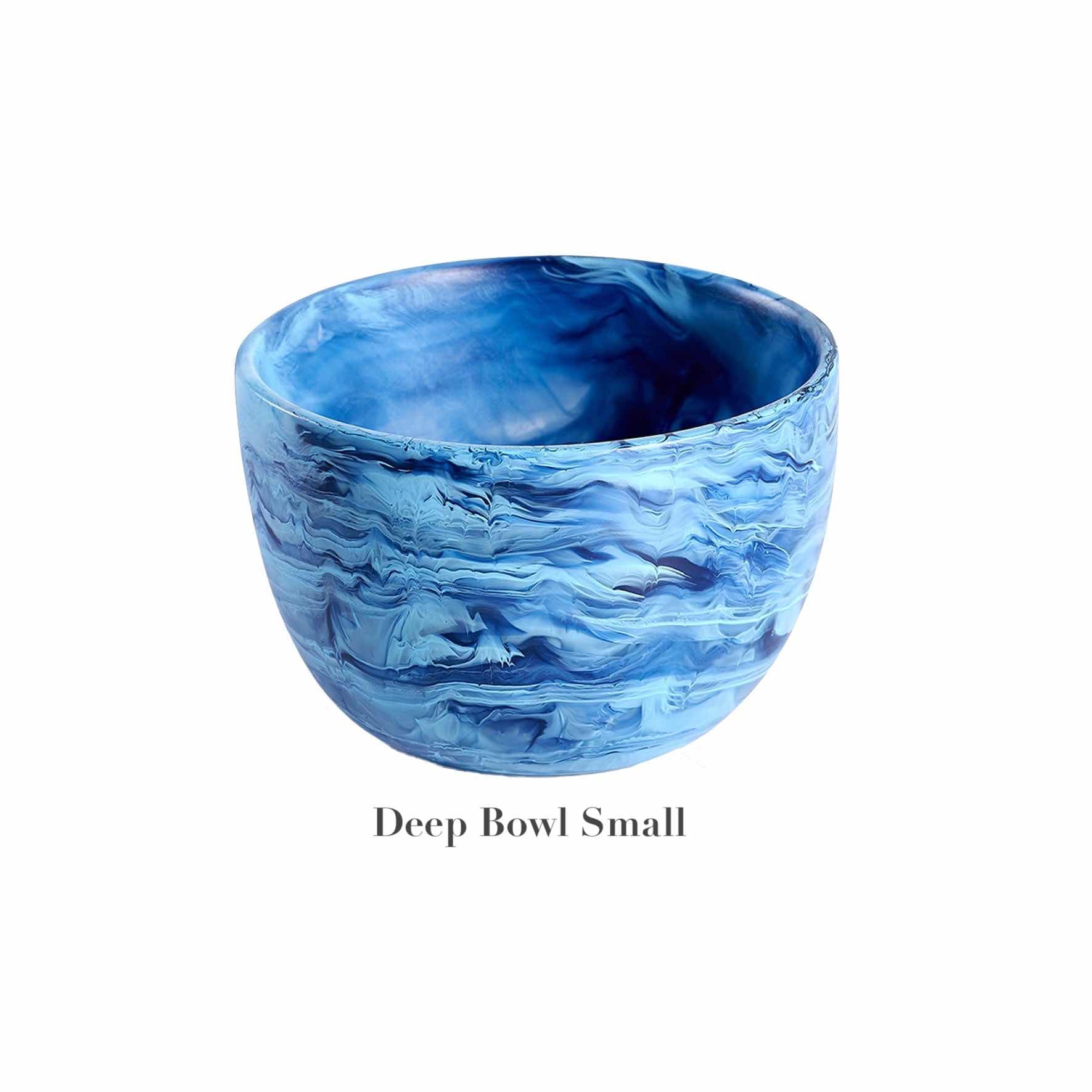 The Denim Resin Serveware Collection by Nashi Home features a small, shatter-resistant deep bowl with a blue marbled design—ideal for adding stylish and practical flair to your decor.