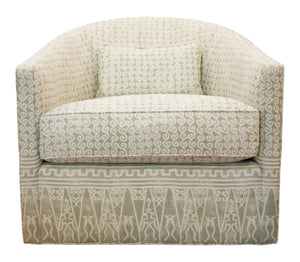 The Baker Dima Swivel Chair features light green and white patterned upholstery with geometric and swirling designs, offers comfortable seating, and includes a matching rectangular pillow.