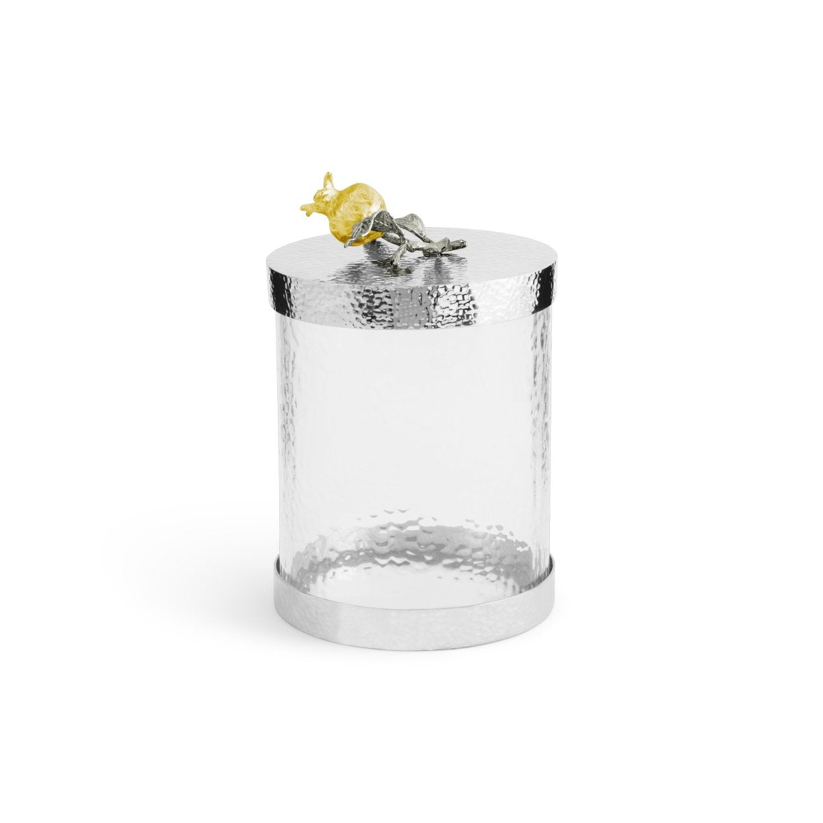 The Michael Aram Pomegranate Silver & Gold Canister features a clear cylindrical glass body with a hammered silver lid, adorned with a decorative yellow and silver pomegranate, celebrating ancient prosperity symbols.