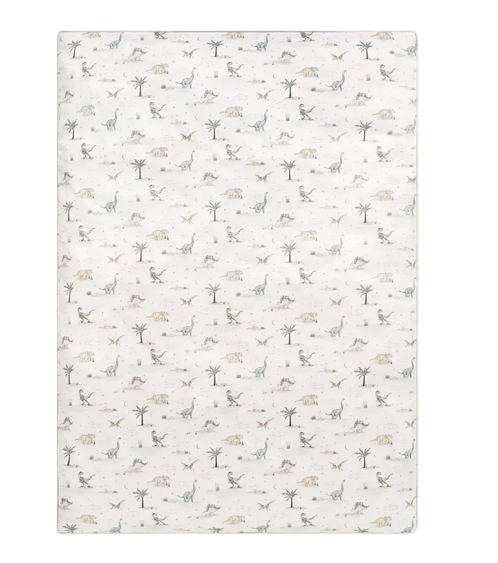 Introducing the Dino Dreams Bedding Collection from Gooselings: a rectangular white area rug featuring a repeating pattern of small, simple dinosaur illustrations, trees, and leaves in muted colors. Specially designed for baby comfort, this breathable rug is OEKO-TEX certified for your peace of mind.
