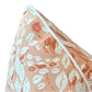 Close-up of the Cowrie Shell Coral Outdoor Pillow by Associated Design, featuring an orange and white seashell pattern with white piping—expertly crafted to elevate any space.
