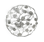 The Michael Aram Botanical Leaf Bread Basket is a round, silver decorative piece with an openwork branch, leaf, and foliage design from the Botanical Leaf Collection.