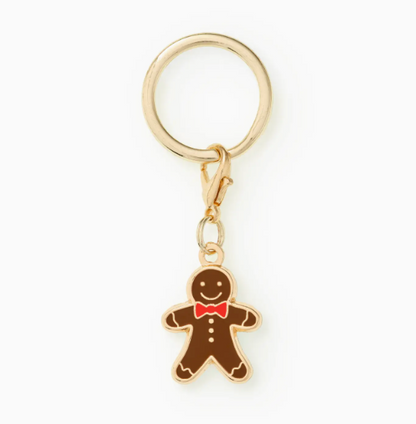 Add a festive touch with the Gingerbread Man Collar Charm by Foggy Dog, featuring a gold metal ring and clasp, plus an adorable gingerbread man with a red bow tie and white buttons.