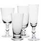 Four classically shaped bowls from the William Yeoward Crystal Fanny Clear Collection, these clear glass goblets with decorative stems come in varying sizes and are elegantly arranged against a white background.