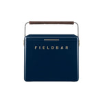 The Gin Trunk by Fieldbar is a navy blue hard case cooler box with a brown handle and "FIELDBAR" in gold on the front, designed for superior thermal performance.
