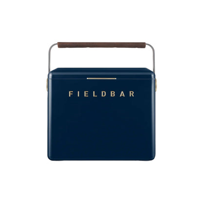 The Gin Trunk by Fieldbar is a navy blue hard case cooler box with a brown handle and "FIELDBAR" in gold on the front, designed for superior thermal performance.