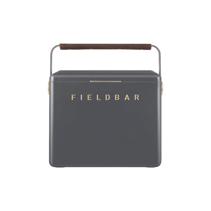 The Gin Trunk by Fieldbar is a dark gray rectangular hard case cooler box with a brown handle and "FIELDBAR" in gold on the front, designed for superior thermal performance.