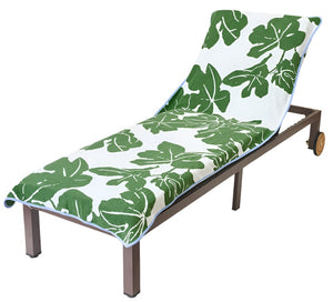 A lounge chair with a brown frame and wheels features a Weezie x Peter Dunham Fig Pool Towel, showcasing a green and white leaf pattern. Made from luxurious long-staple cotton, it offers ultimate poolside comfort.